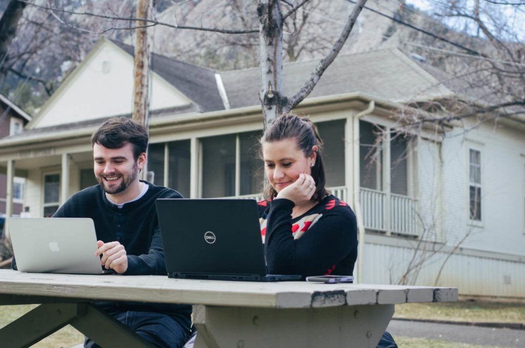 Man and woman on laptops at Chautauqua
