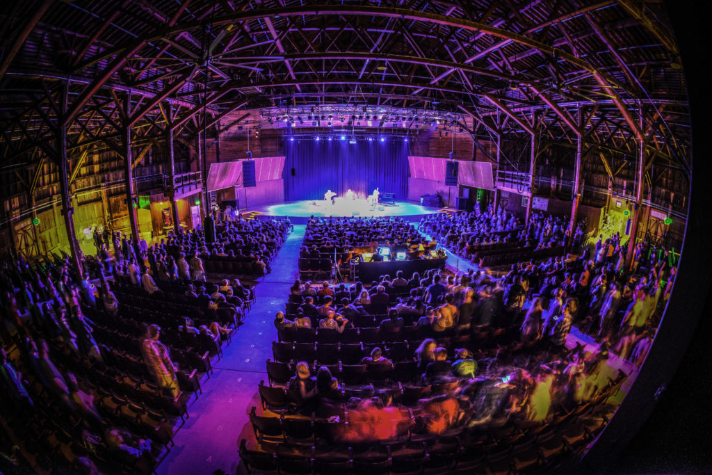 Fish eye image of concert at Chautauqua Auditorium with colored lights