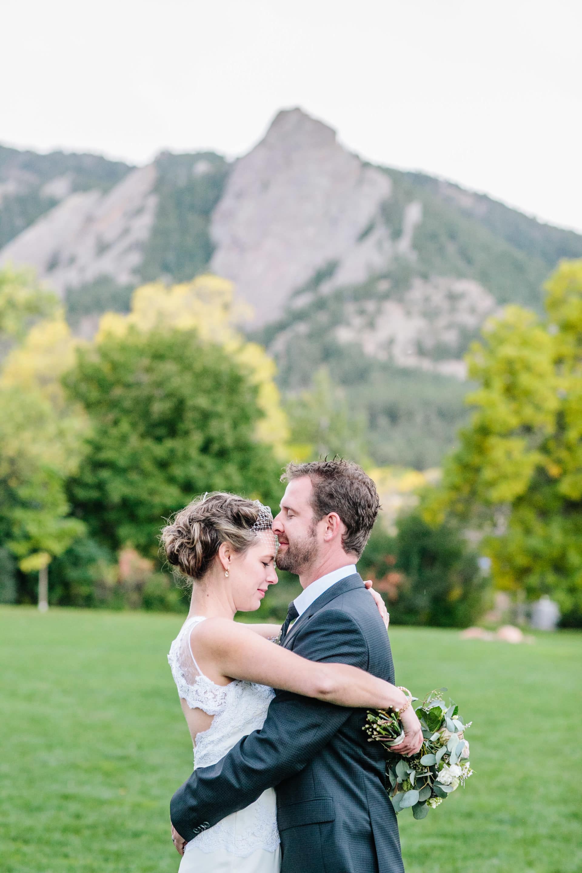 Couple on green with Flatirons backdrop
