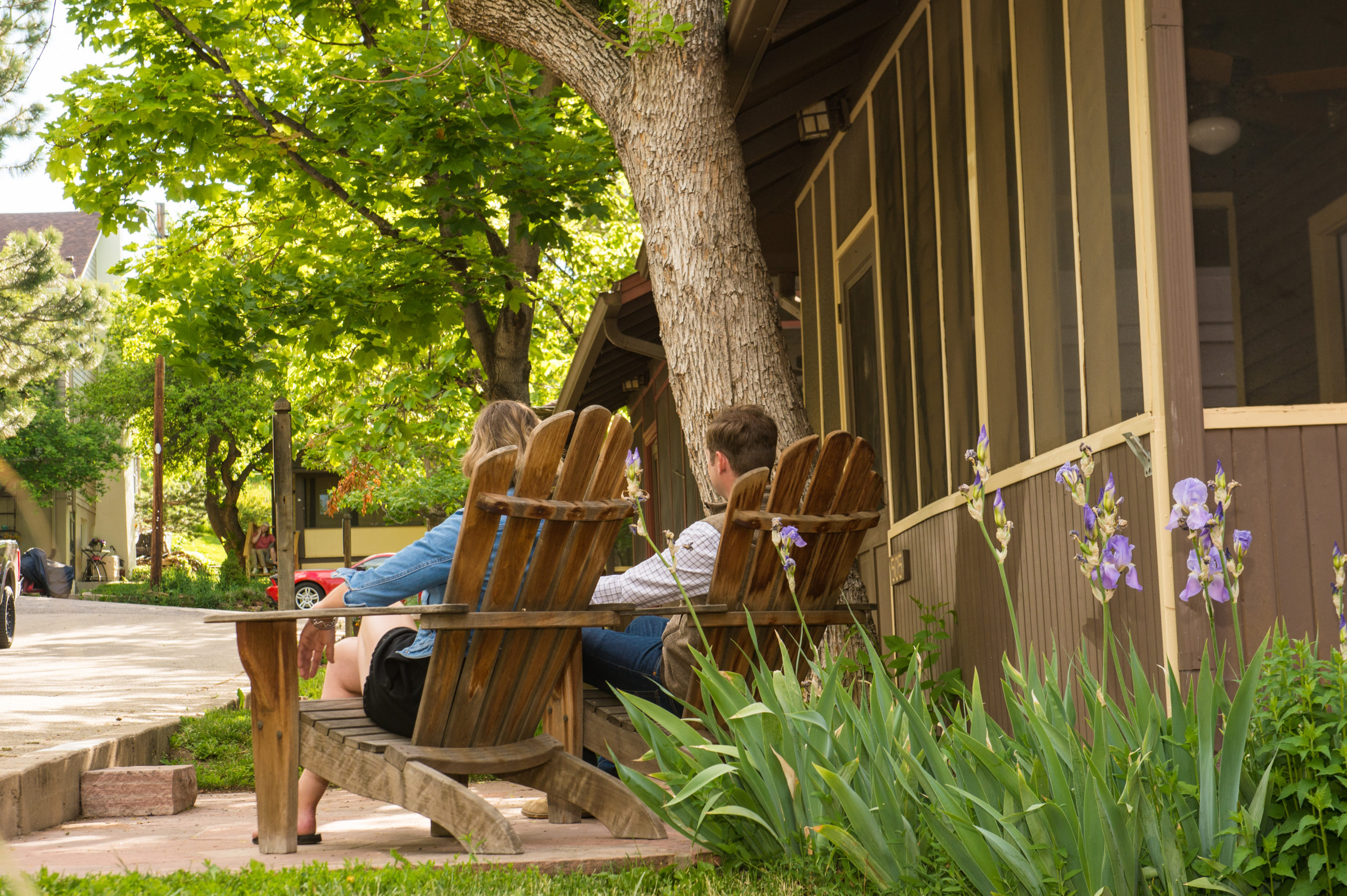 Couple relaxing in chairs outside Chautauqua cottage