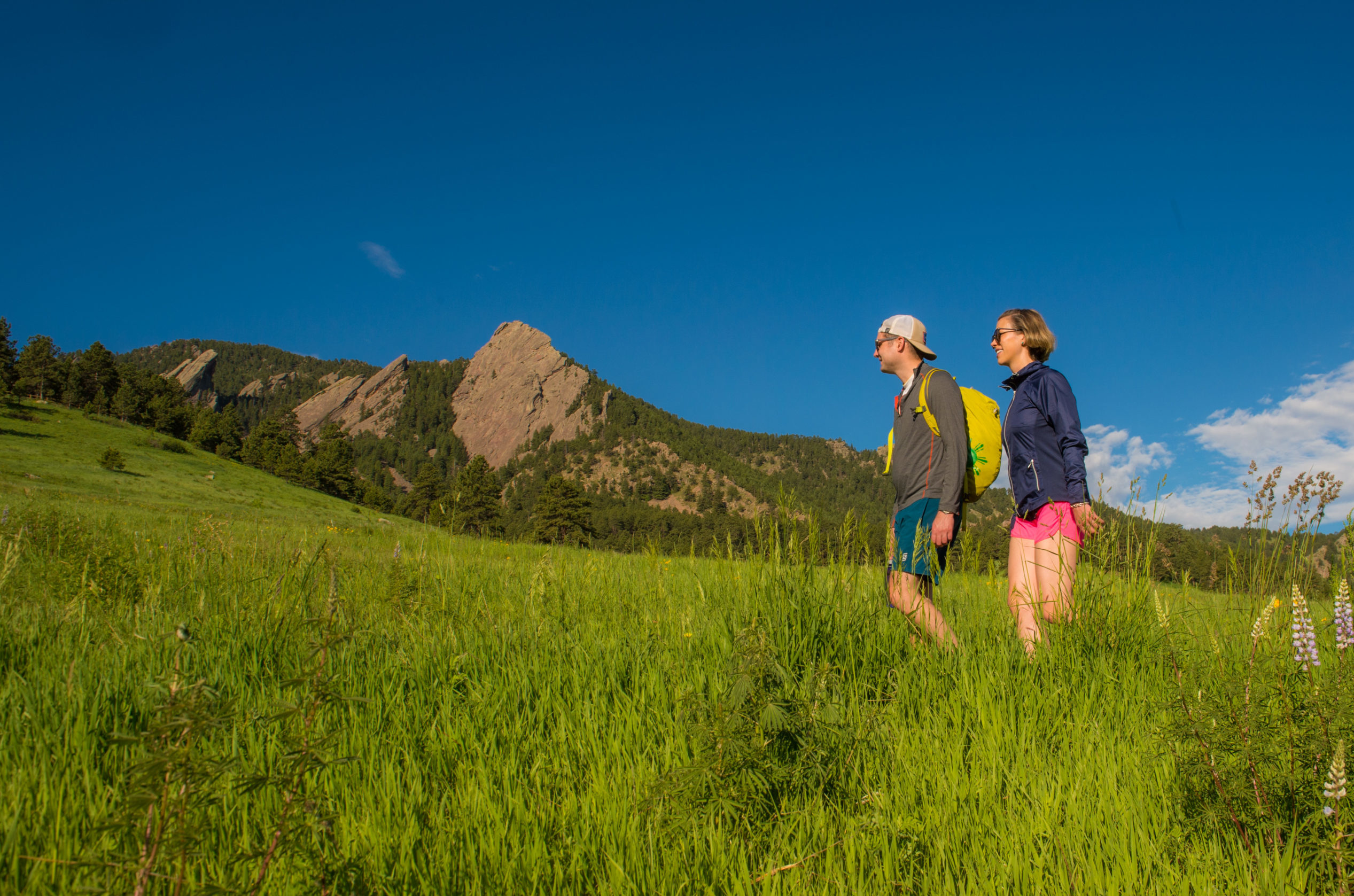 Couple hiking in Chautauqua Meadow, Boulder in summer