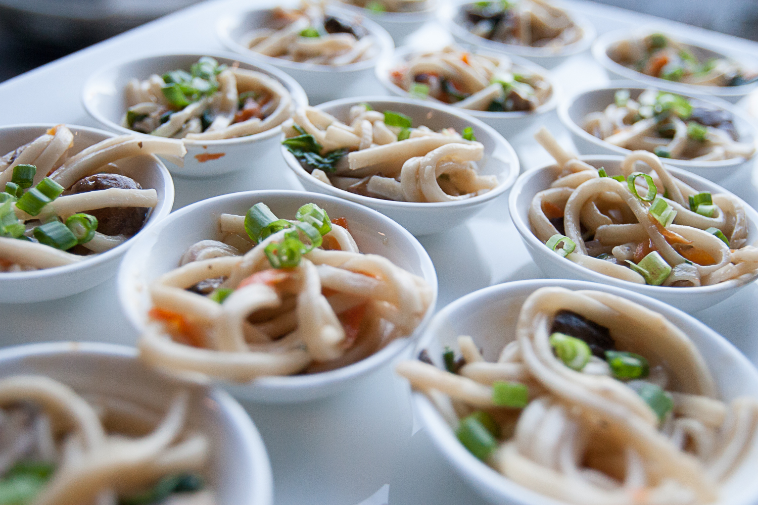 many small bowls of udon noodles
