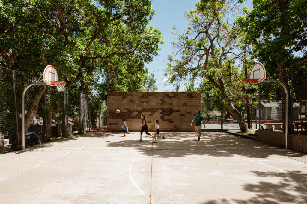 Family playing basketball on Chautauqua court
