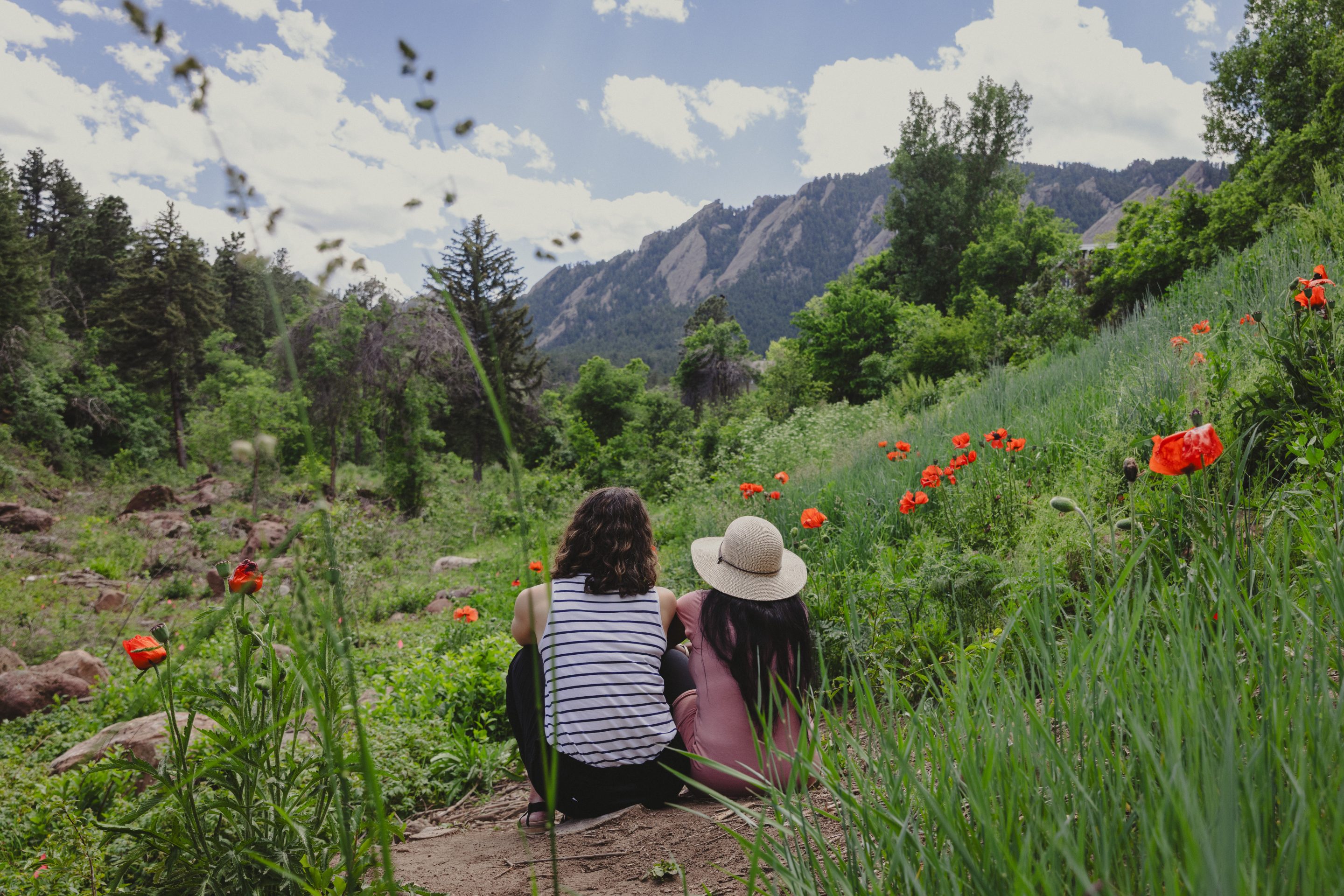 three women hike uphill